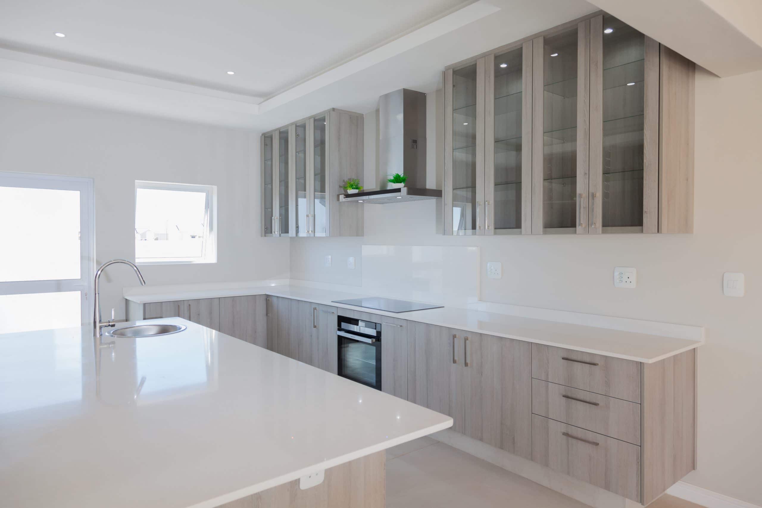 white grey kitchen with screed floor grundig appliances