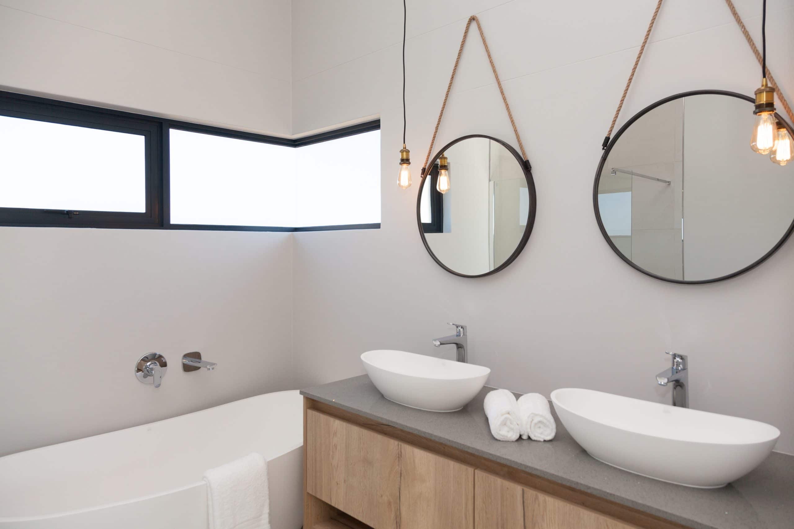 modern bathroom with round hanging mirror
